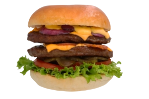 Dubbele 100% rundvlees burger (100 gr.) op een luxe broodje met twee plakjes cheddar, gebakken bacon(kip), gebakken ui, sla, tomaat, augurk en signature burgersaus.